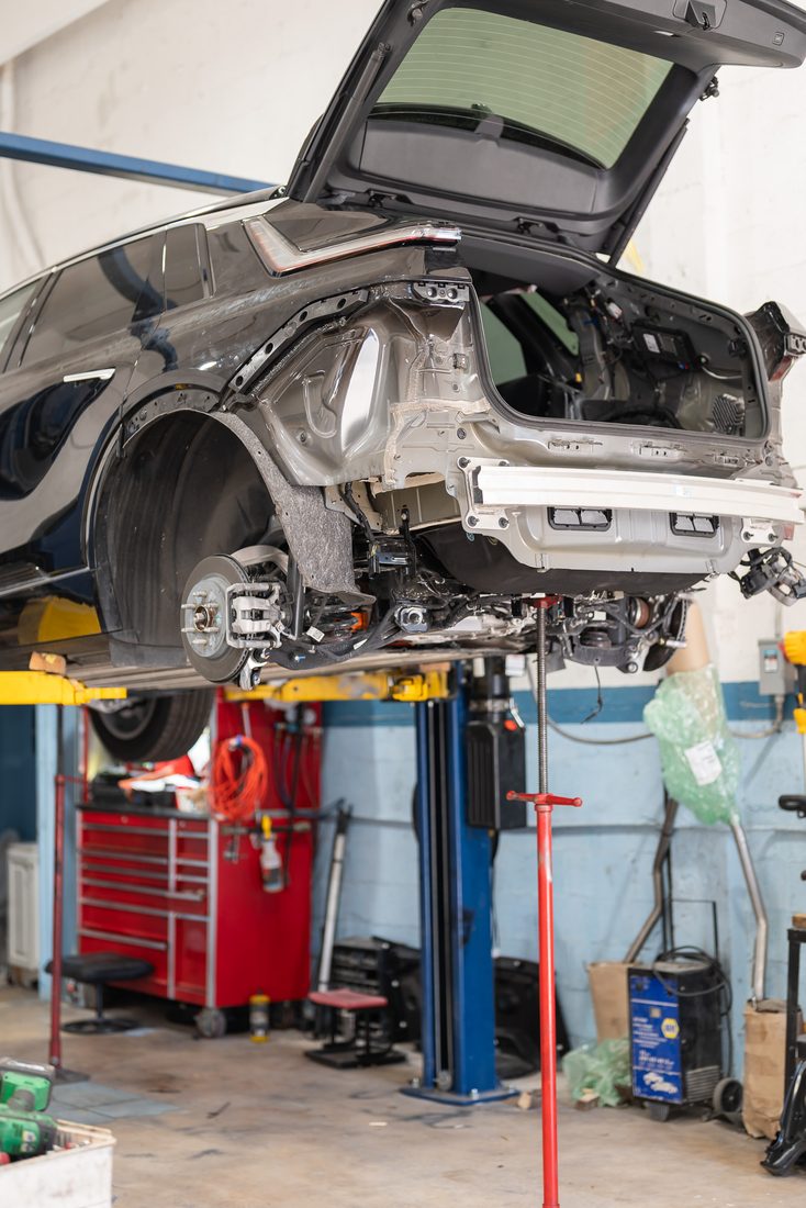 A vehicle raised on a lift inside the Precision shop