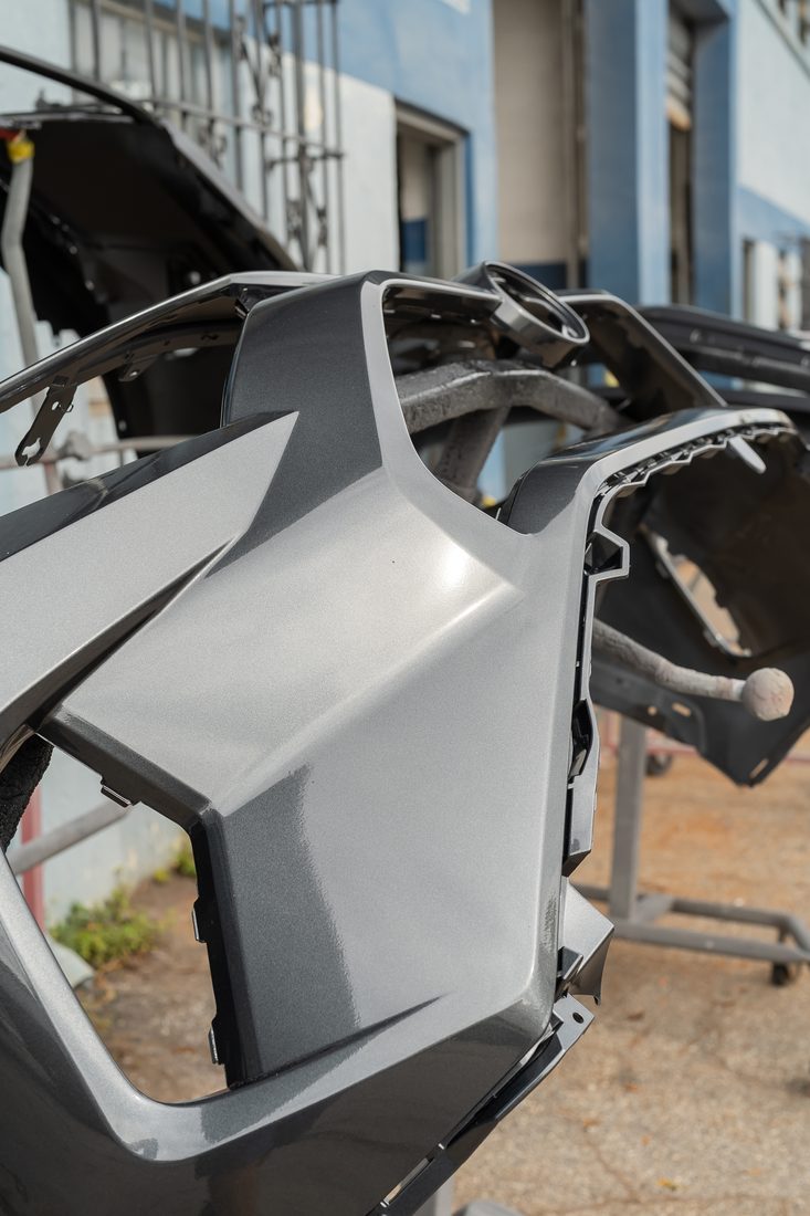 Bumper covers and grille assemblies staged after refinishing