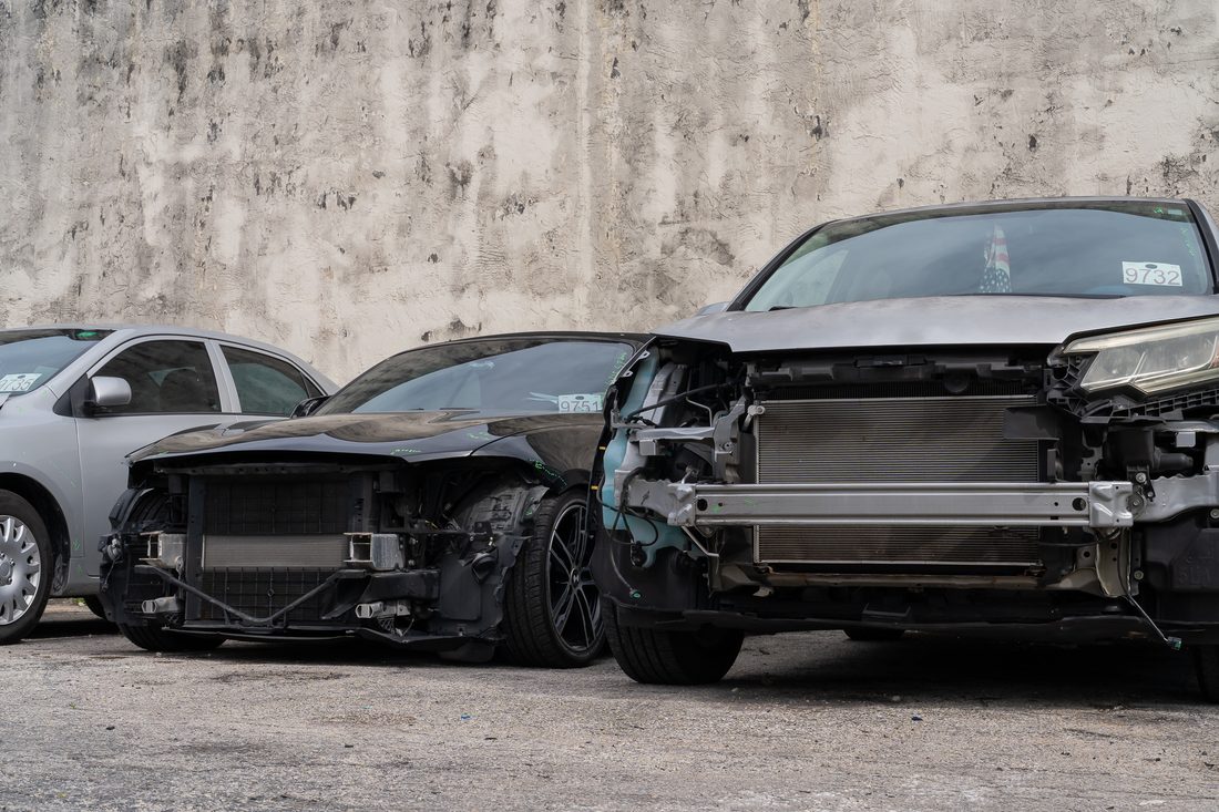Collision-damaged vehicles staged in the yard awaiting estimates
