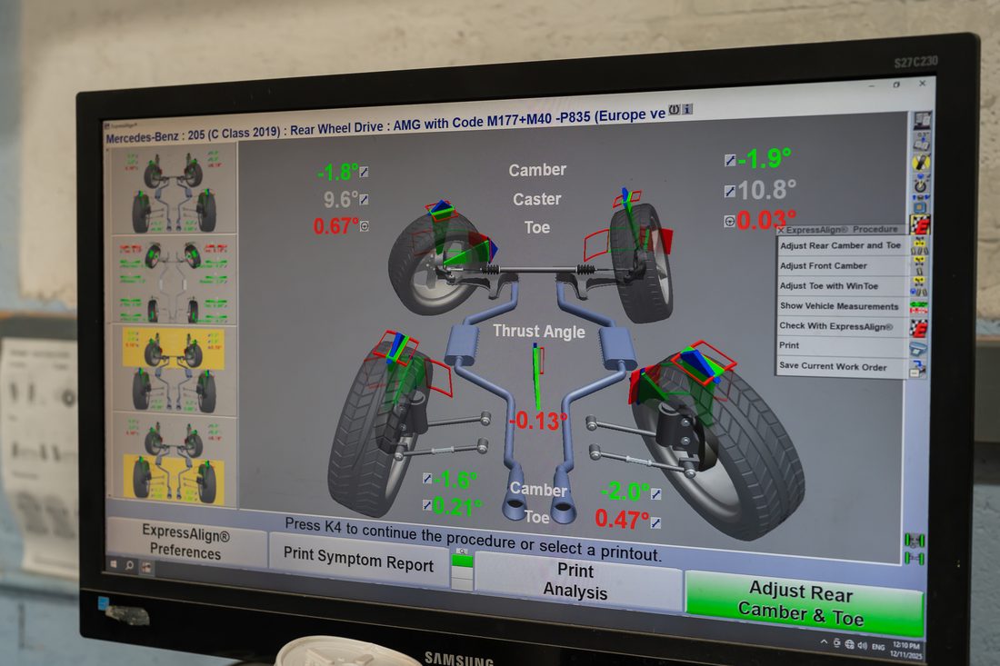 Four-wheel alignment readout showing camber, caster and toe after structural repair