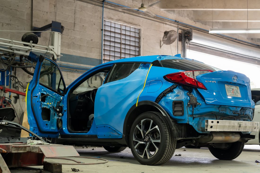 Rear quarter of the same vehicle with panels and lighting removed for repair
