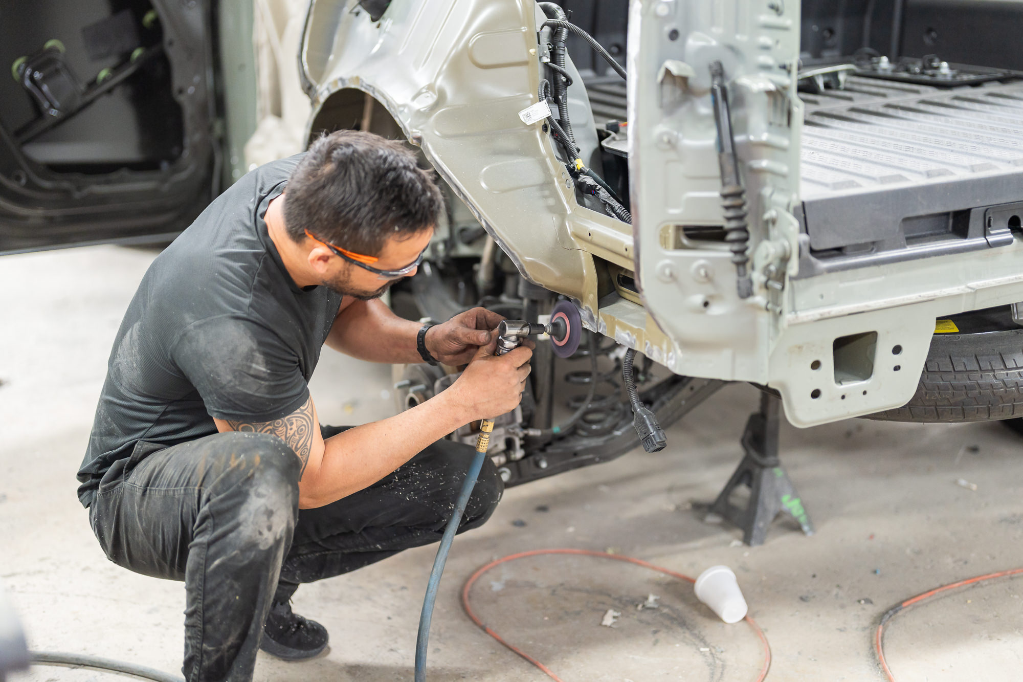 Car bumper repair on red sports car