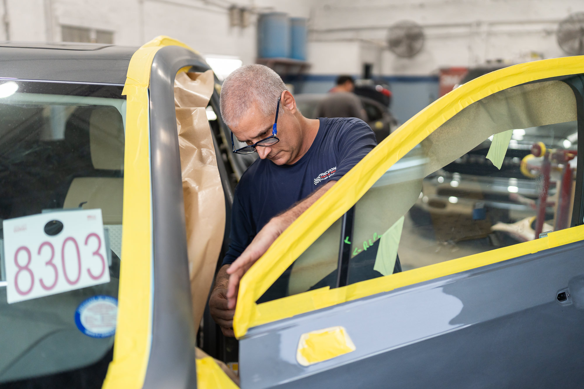 Technician masking vehicle for fender repair